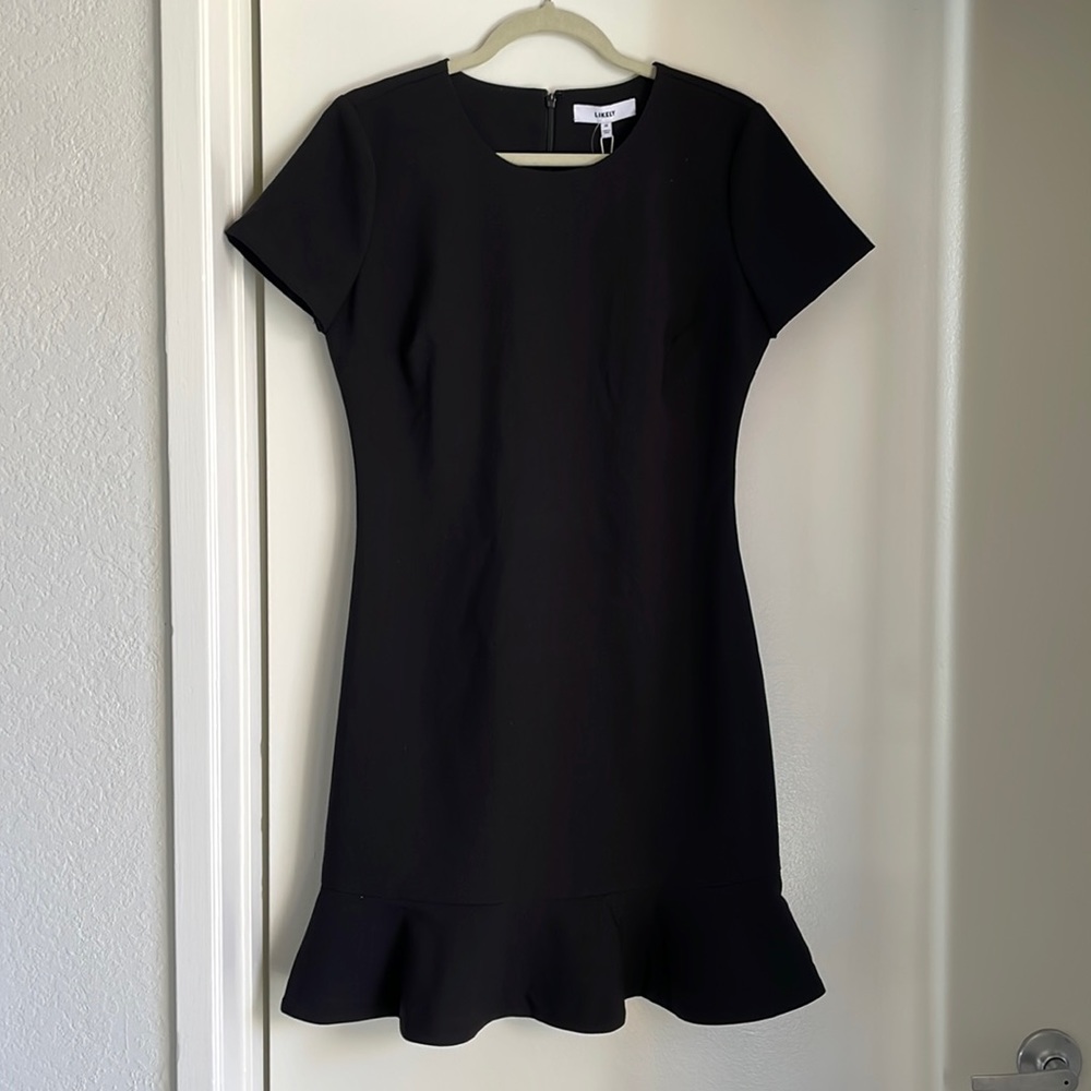 Likely peplum skirt black mini dress. Fit and flare